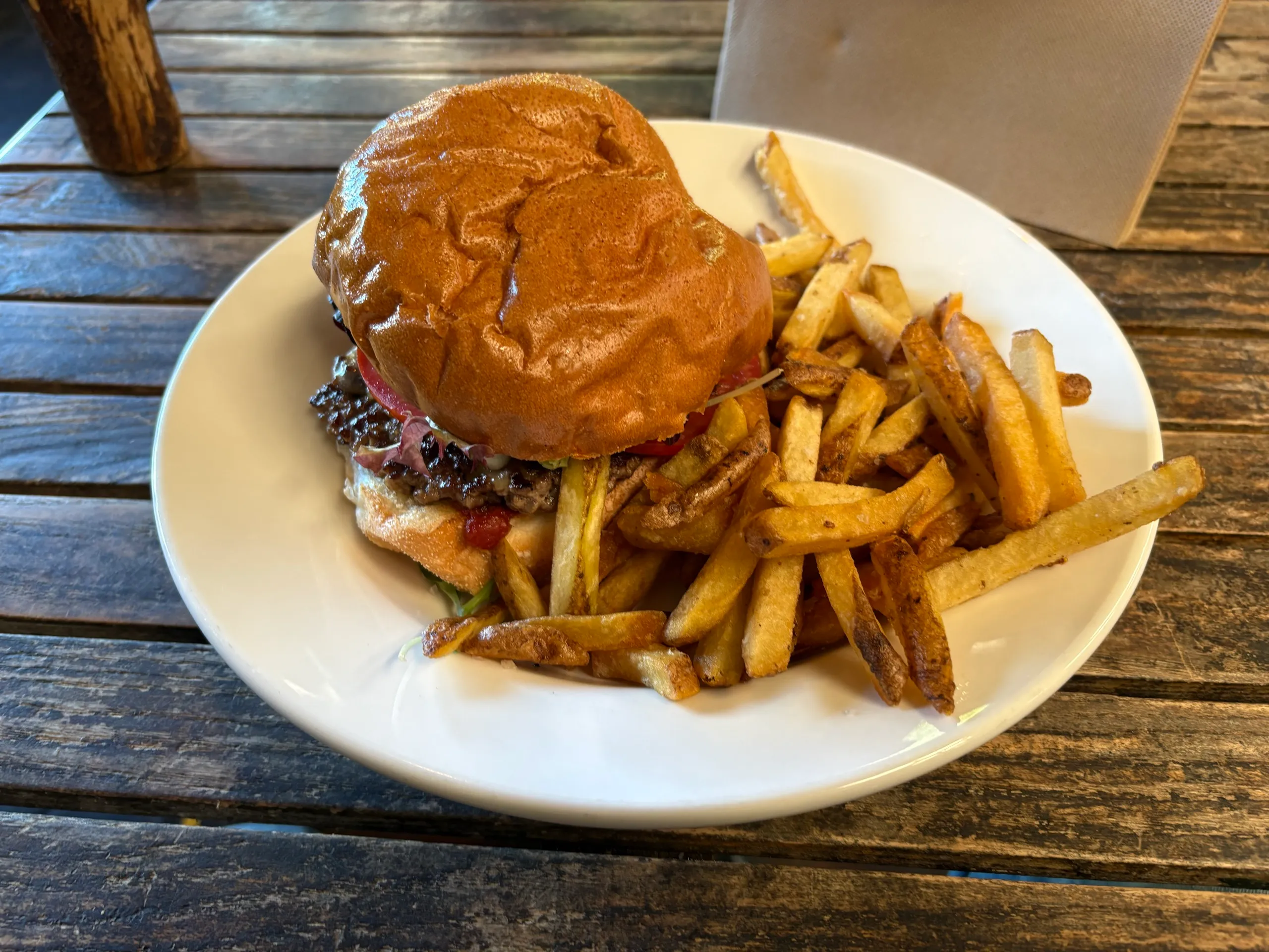 A burger and chips on a plate at a Bellingen cafe