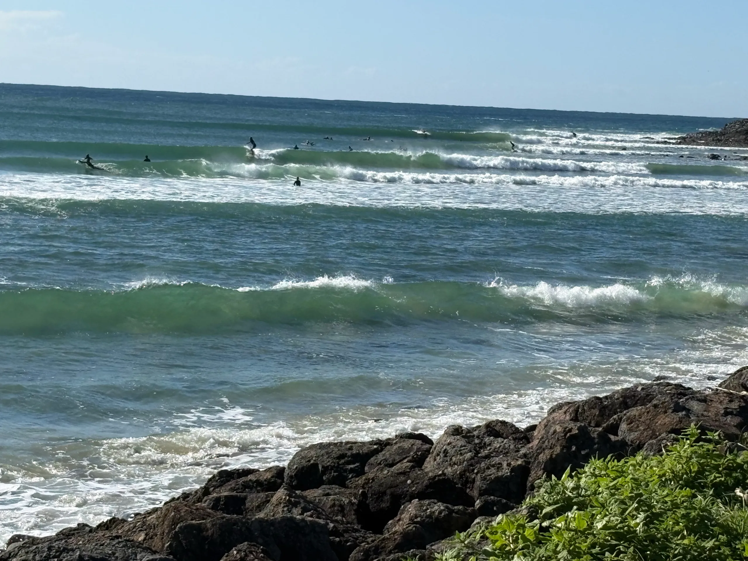 Surfers lined up in the water at the Crescent Head point break