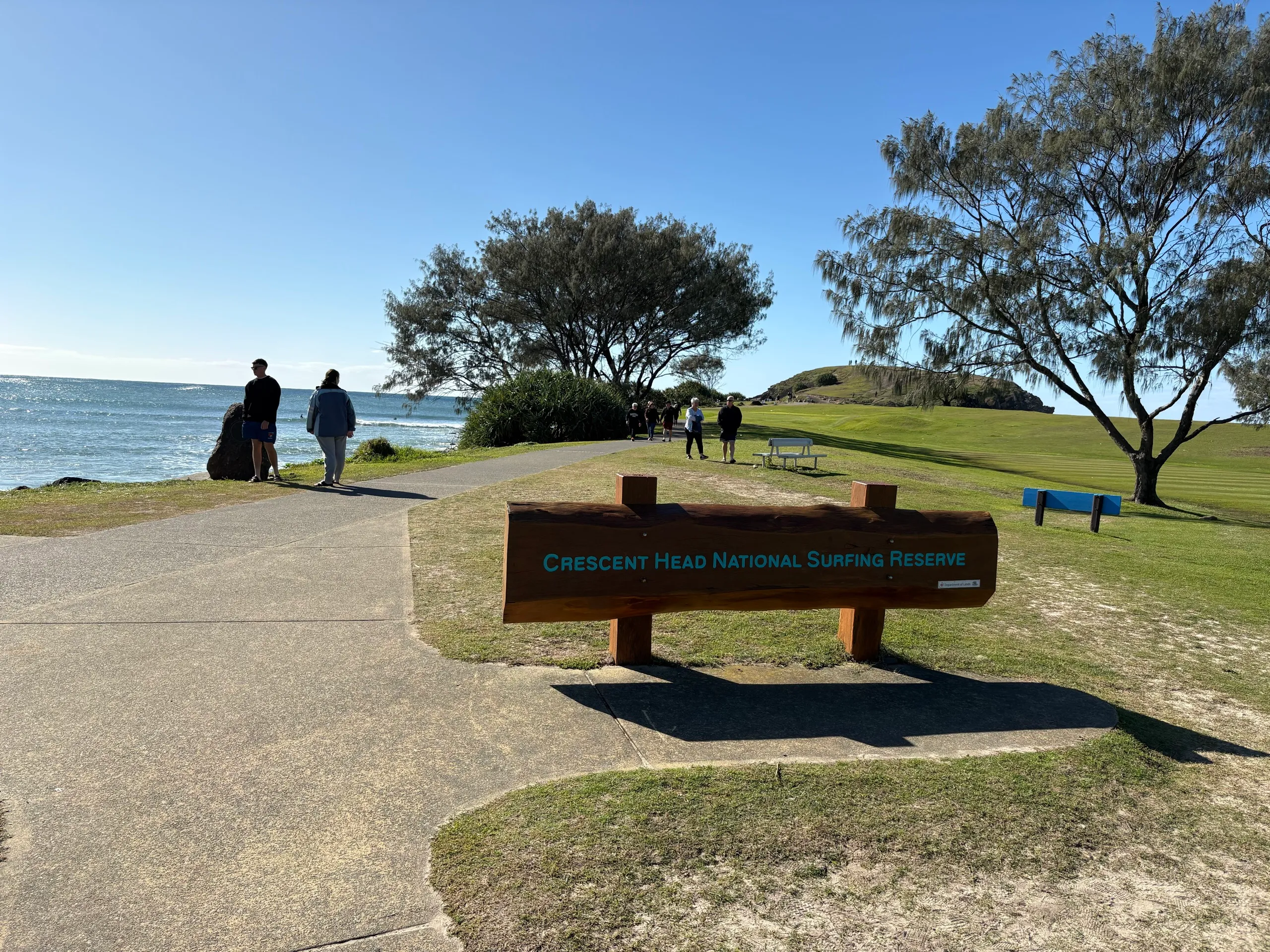 The Crescent Head National Surfing Reserve sign on the headland by the point