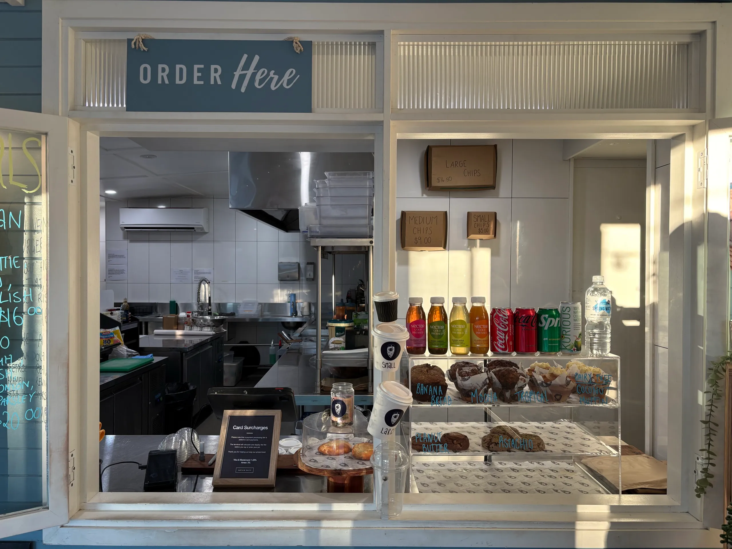 The order window at Captain Salty in Hat Head, with coffee, cold drinks and baked goods