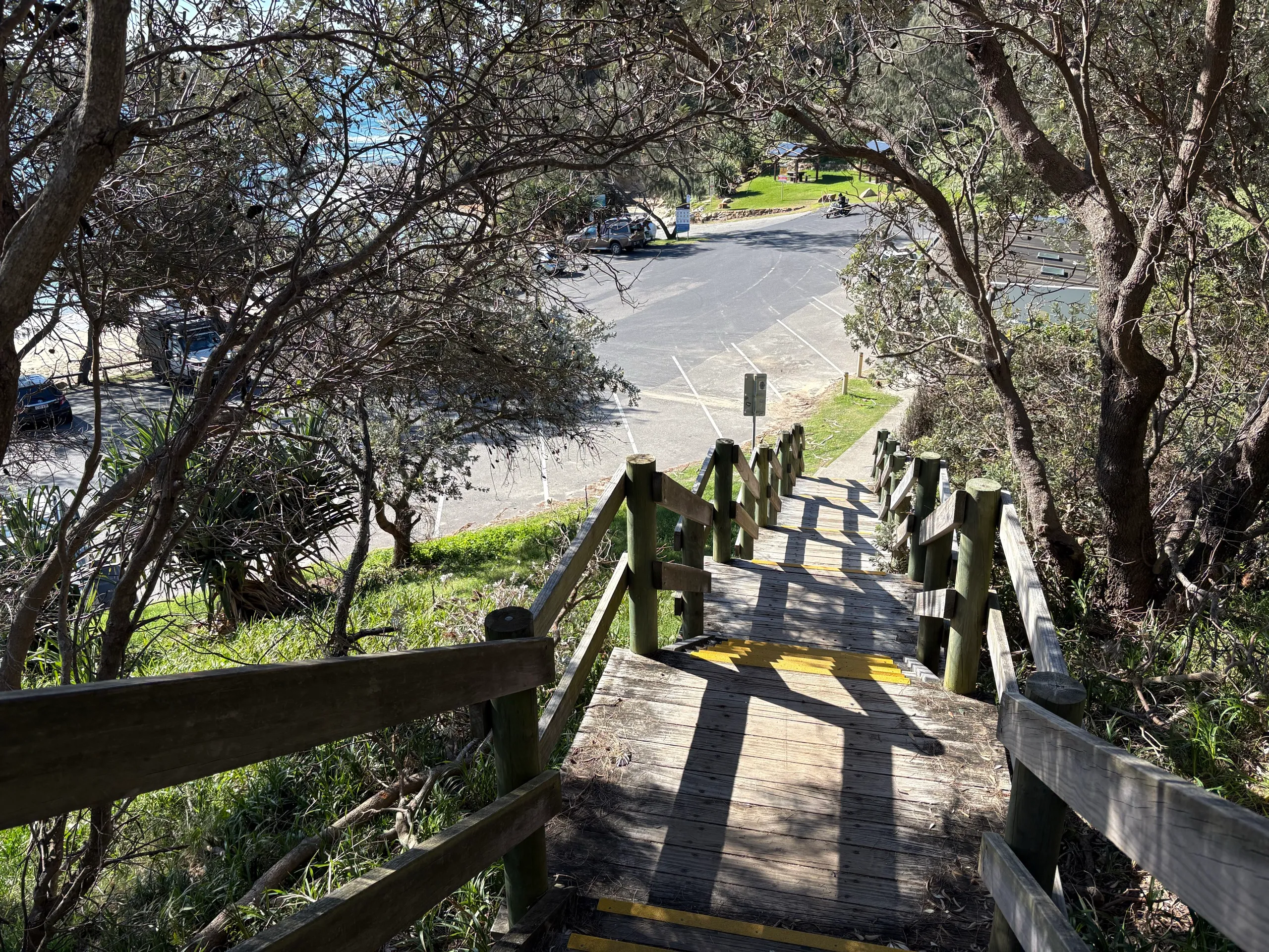 Timber stairs leading down through bush to the beach car park at Nambucca Heads