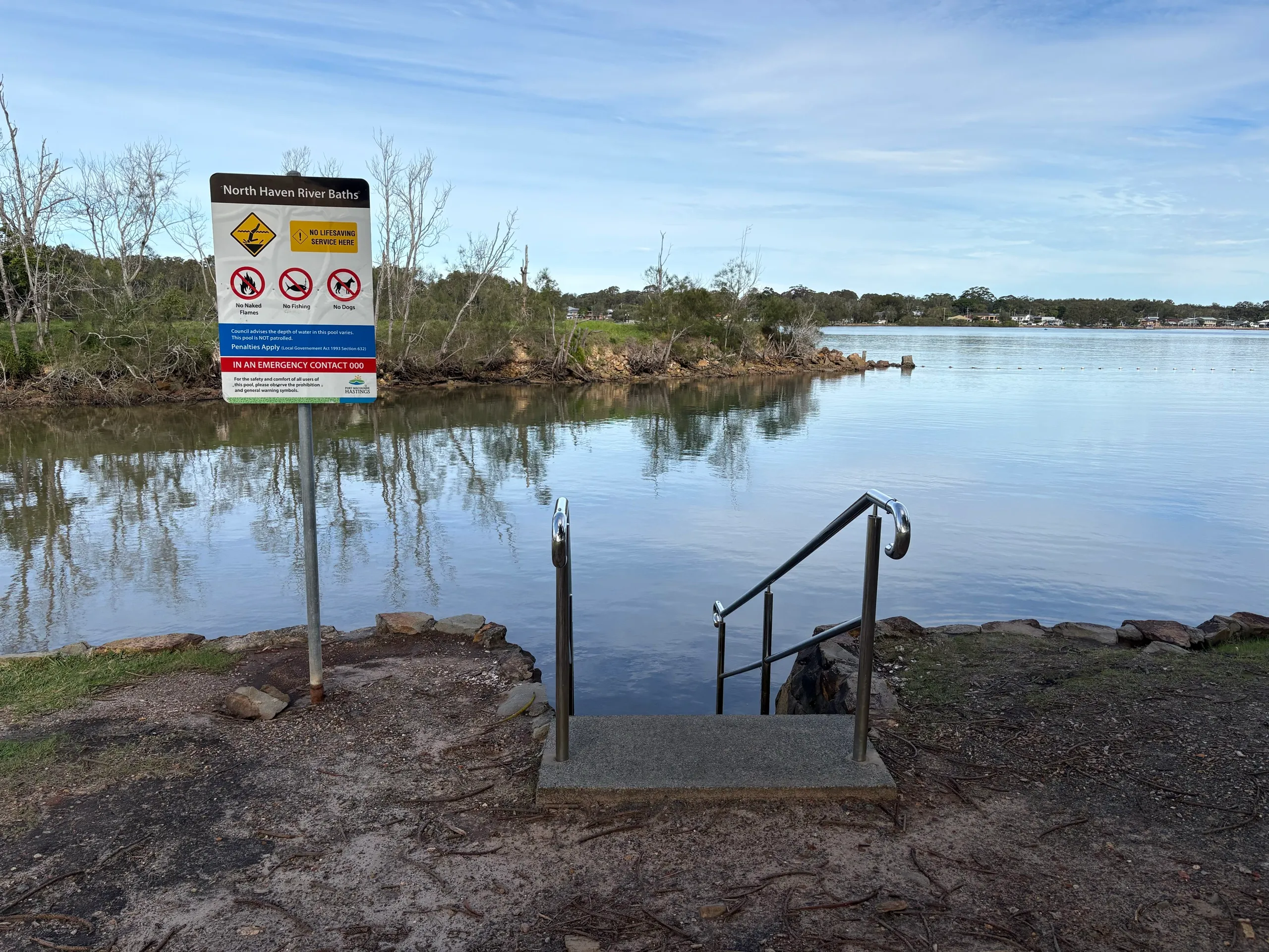 The North Haven River Baths sign and steps into the calm river water
