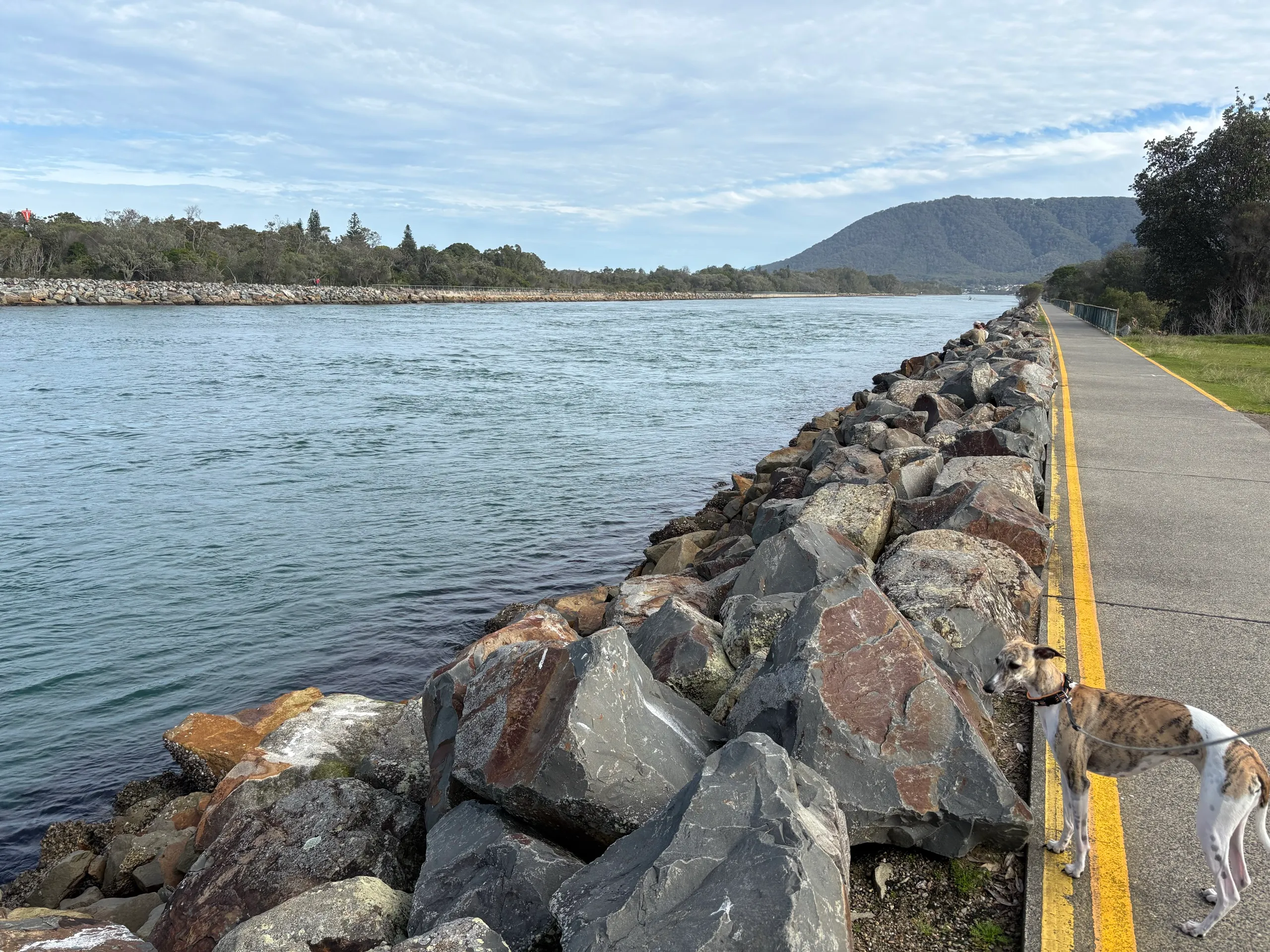 A walking and cycling path along the rock breakwall beside the Camden Haven River