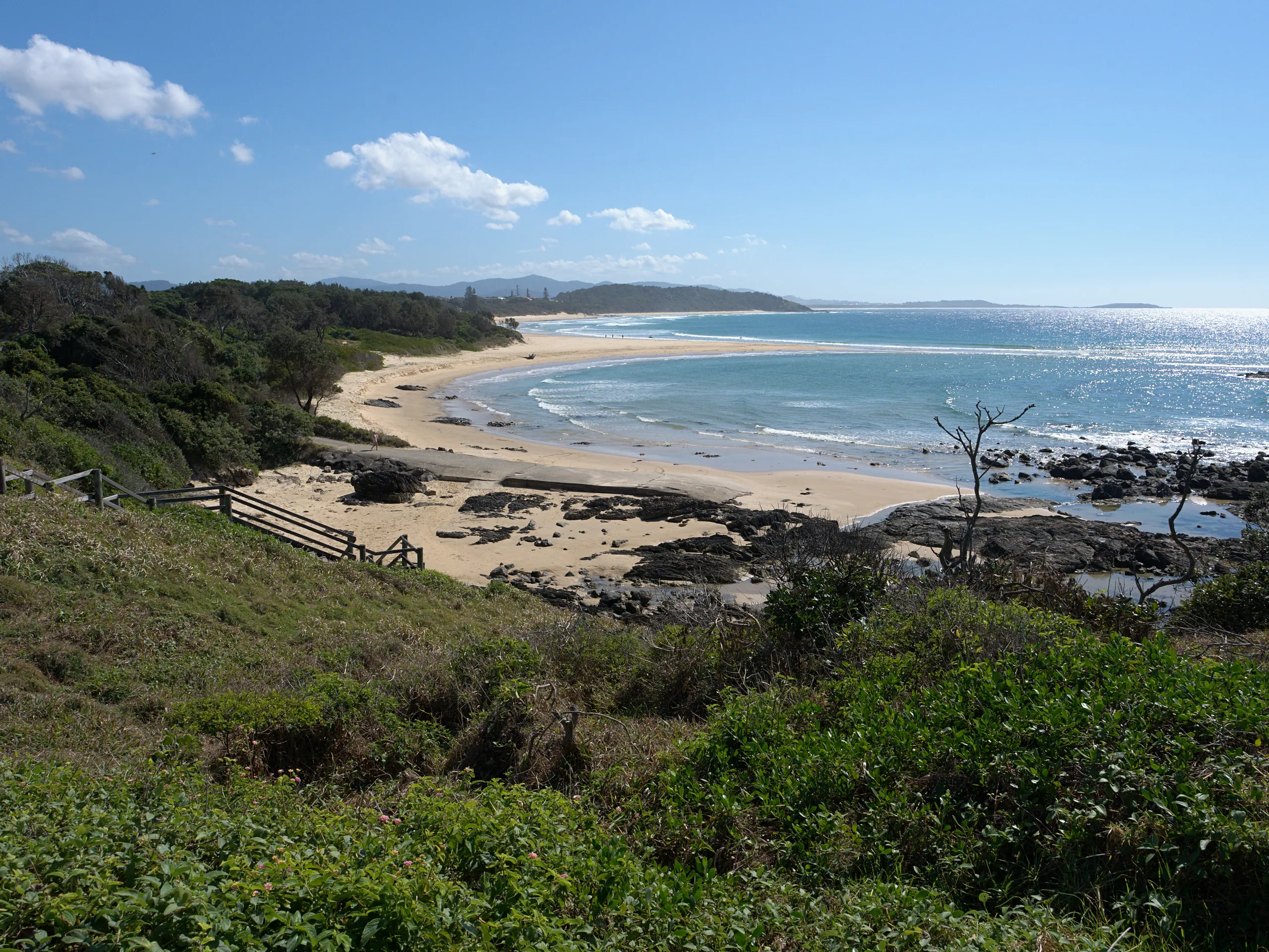 Sawtell Beach curving north from the rocks below the headland toward Boambee Head