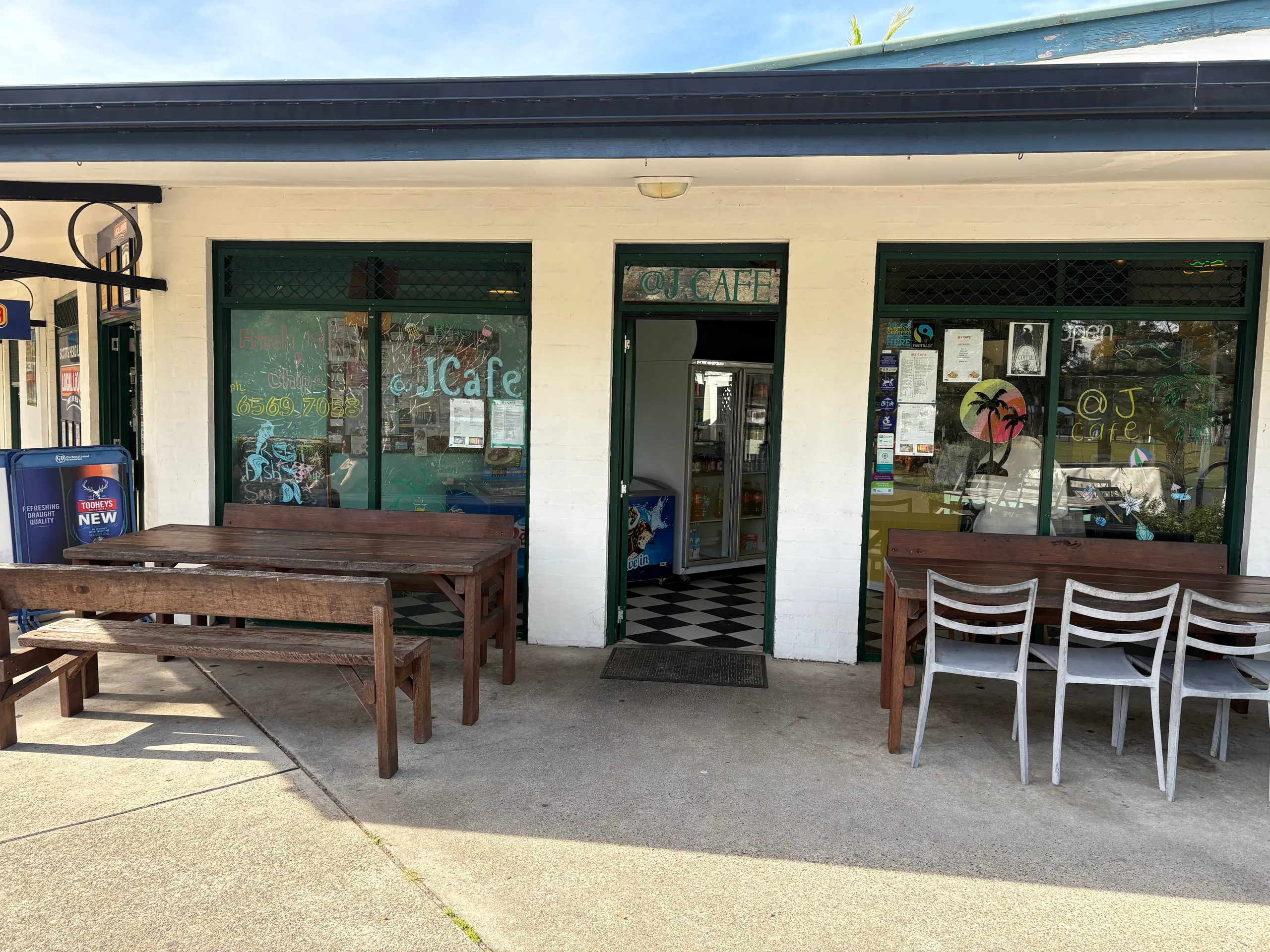 The green shopfront and outdoor tables of a village cafe at Scotts Head