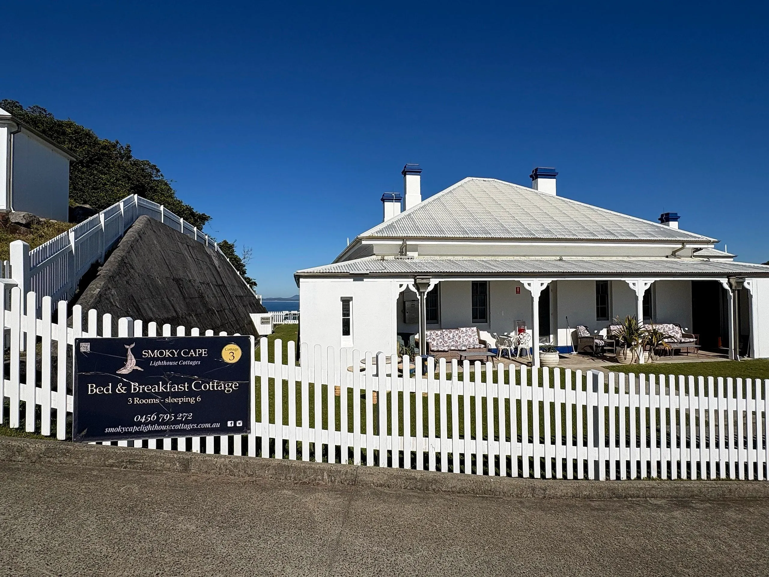 The Smoky Cape bed and breakfast cottage behind its white picket fence