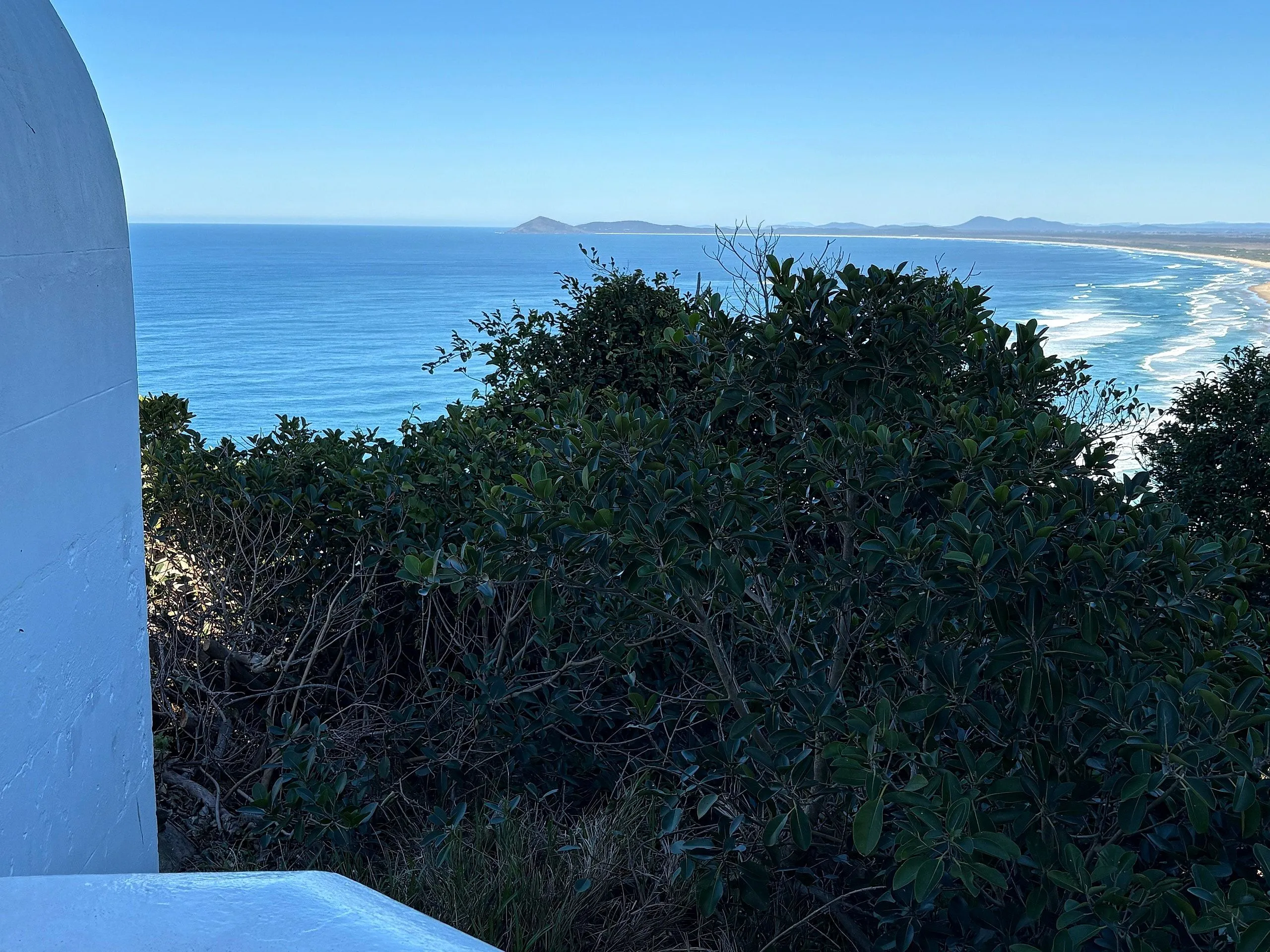 Looking south past the base of the lighthouse toward the distant beach