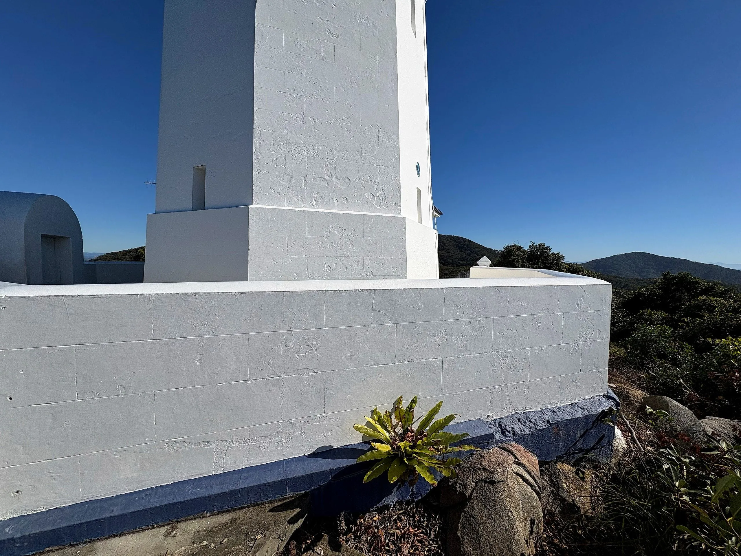 The base of the lighthouse tower with its navy blue plinth