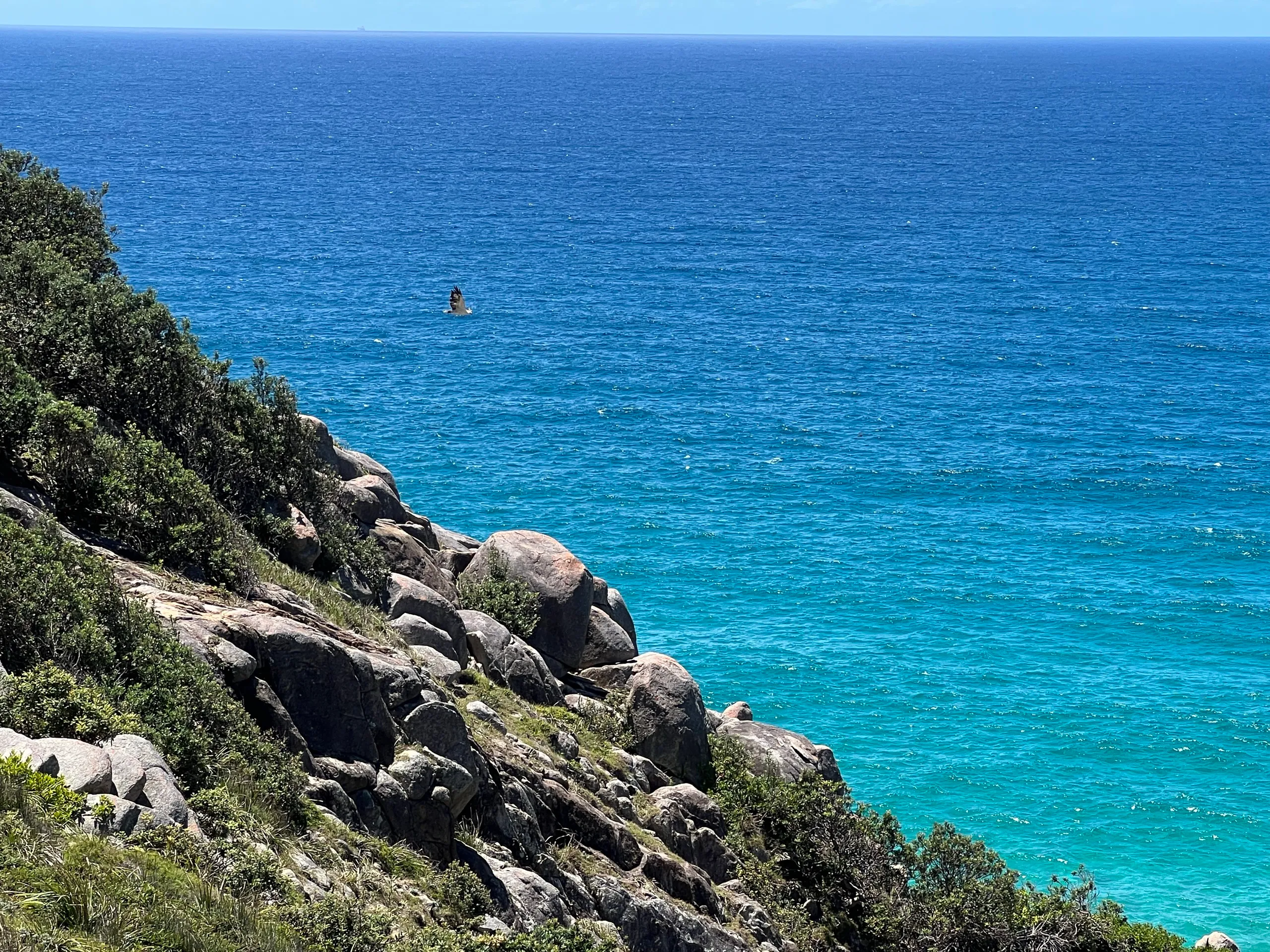 Granite boulders and clear blue water on a rocky headland at South West Rocks