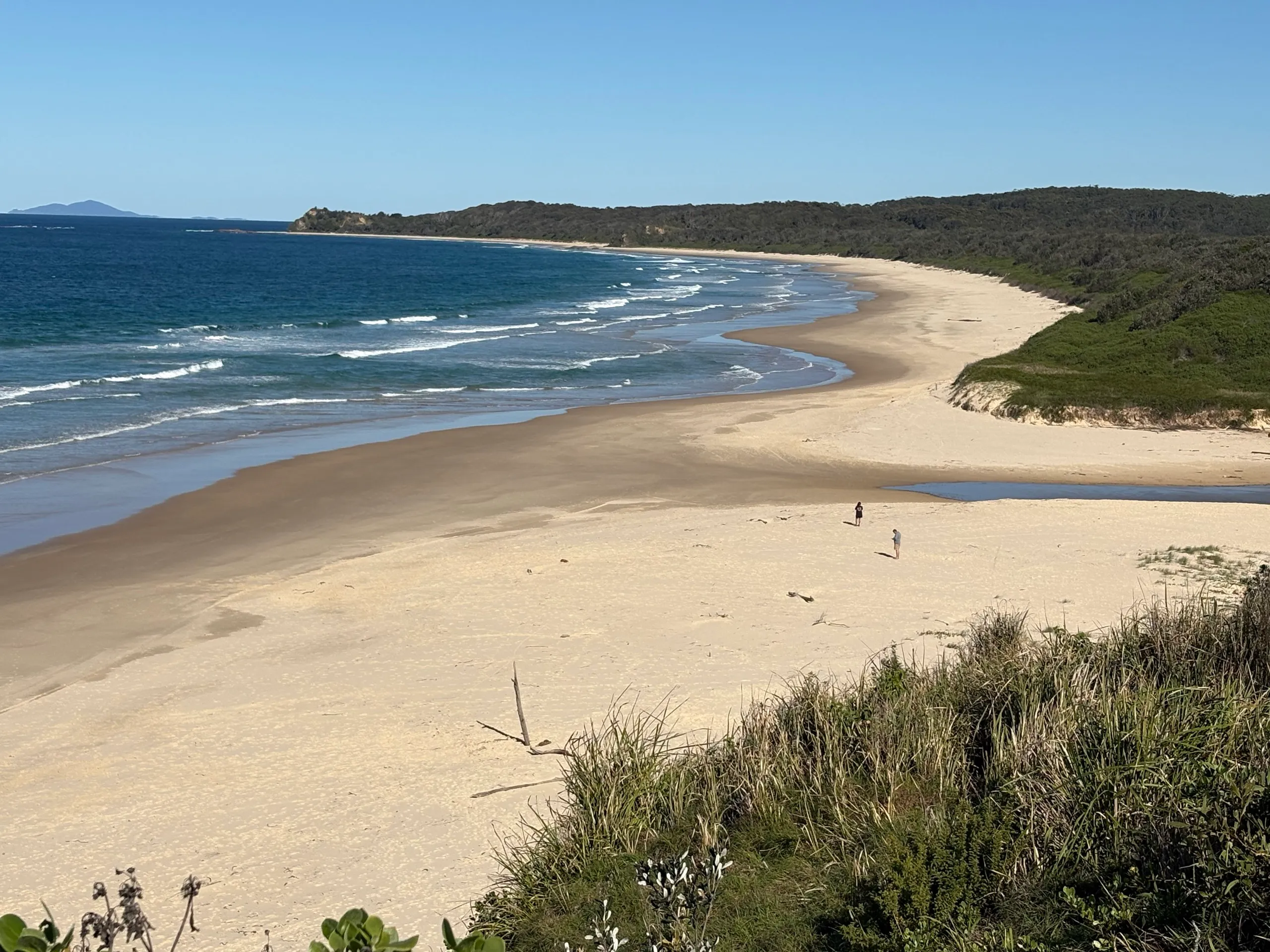 The long empty curve of the beach south of Urunga toward Hungry Head